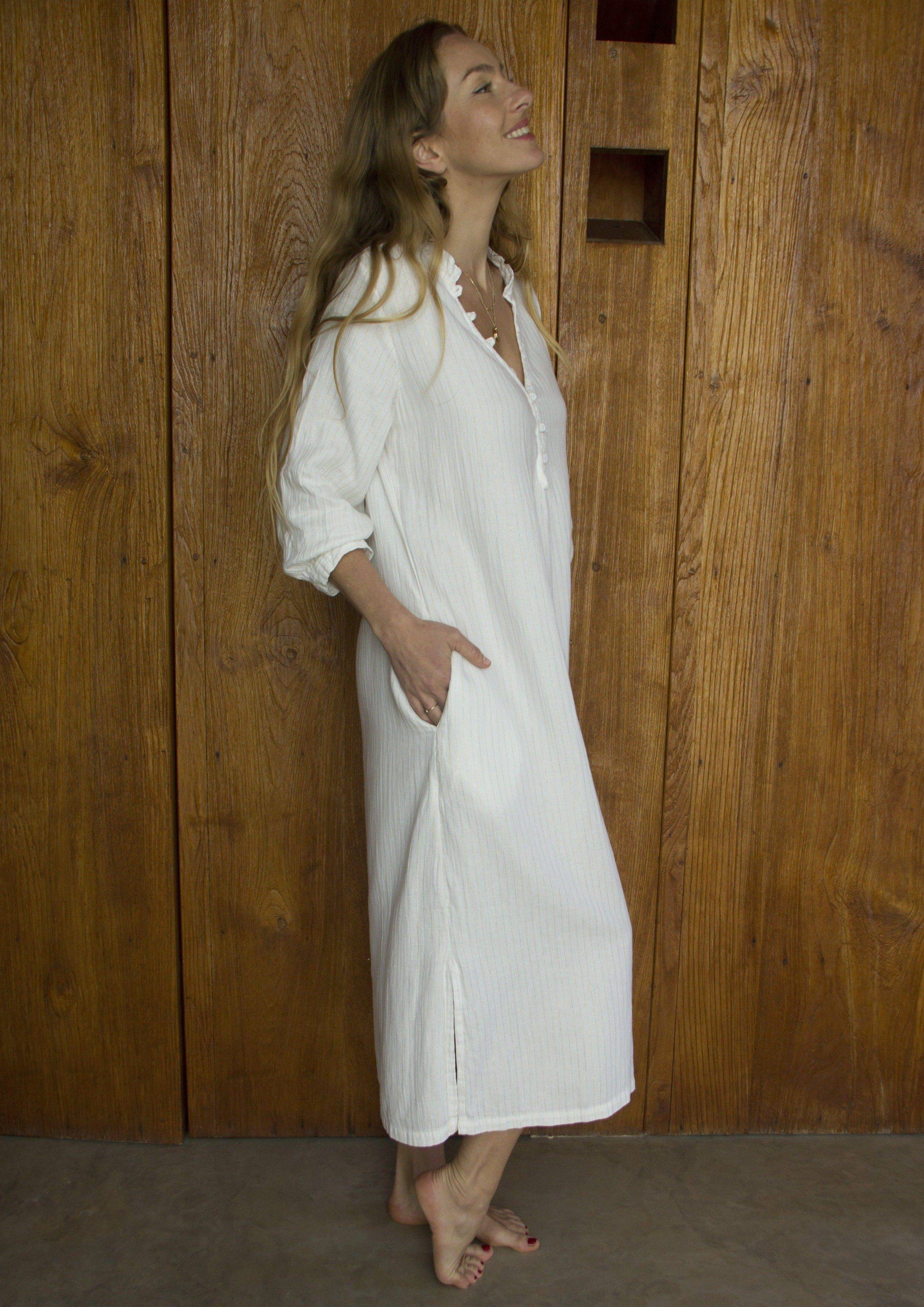 FRESNO dress • Soft cotton three-quarter-length dress featuring a button loop placket v-shaped neckline with mock collar, three quarter length button cuffed sleeves, side pockets, and side slits.