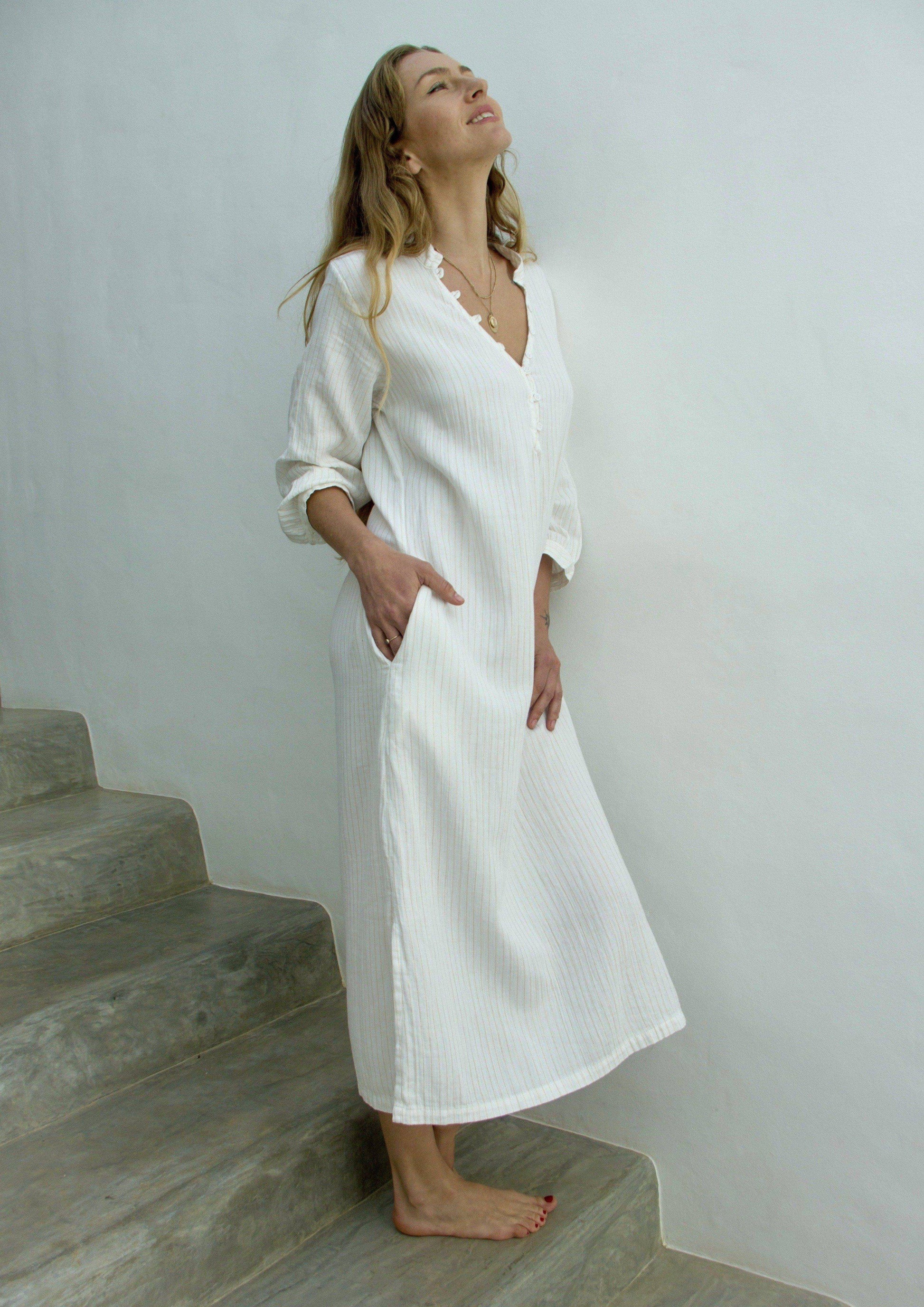 FRESNO dress • Soft cotton three-quarter-length dress featuring a button loop placket v-shaped neckline with mock collar, three quarter length button cuffed sleeves, side pockets, and side slits.