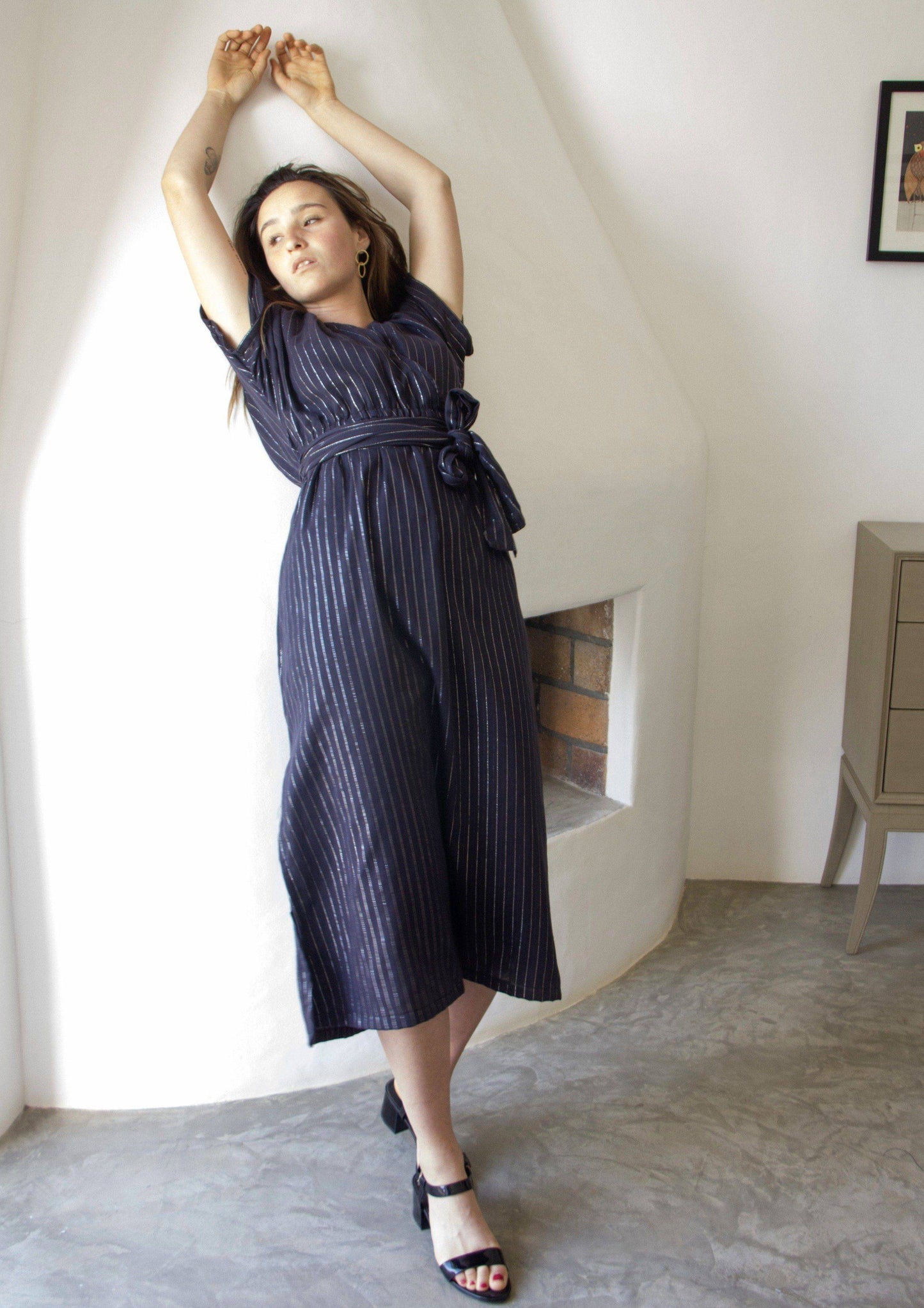 DELPHINE DRESS •  maxi dress gently cinched at the waist for a feminine fit featuring a wrap-around belt, open low v-neckline with wide short sleeves, and side slits in the skirt in a silver fleck pinstripe fabric. Available in one size.